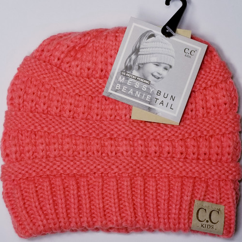 Product photo of the KIDS C.C MESSY BUN BEANIE CORAL baby beanie hat, showing the soft knit fabric, color, and pom pom detail, available at Forever And Always Online.