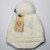 Product photo of the BABY C.C BEANIE w/BRIM BEIGE baby beanie hat, showing the soft knit fabric, color, and pom pom detail, available at Forever And Always Online.
