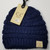 Product photo of the BABY C.C BEANIE NAVY baby beanie hat, showing the soft knit fabric, color, and pom pom detail, available at Forever And Always Online.