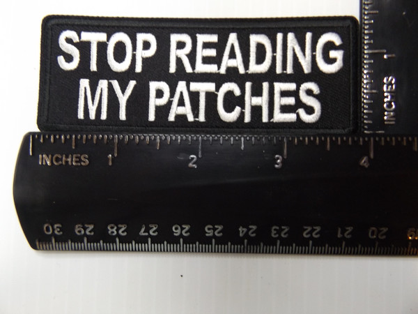 Flat-lay product photo of the STOP READING MY PATCHES embroidered iron-on biker patch, showing full color detail, lettering, and stitching, sold at Forever And Always Online.