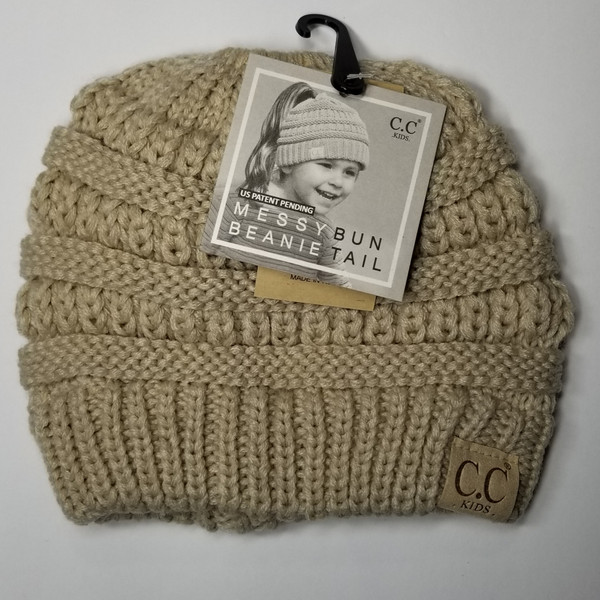 Product photo of the KIDS C.C MESSY BUN BEANIE BEIGE baby beanie hat, showing the soft knit fabric, color, and pom pom detail, available at Forever And Always Online.