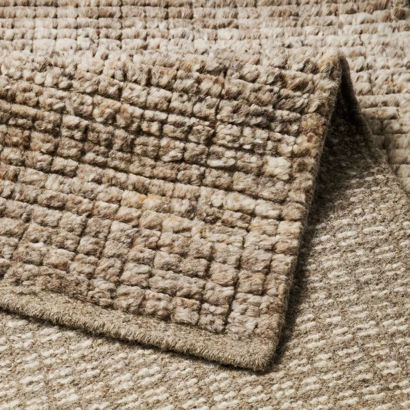 Kensington Natural rug corner, folded to show the hand-knotted pile