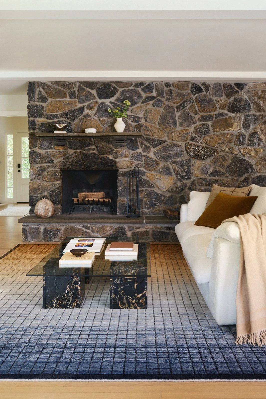 Sedona Earth loom-knotted wool rug in front of a stone fireplace