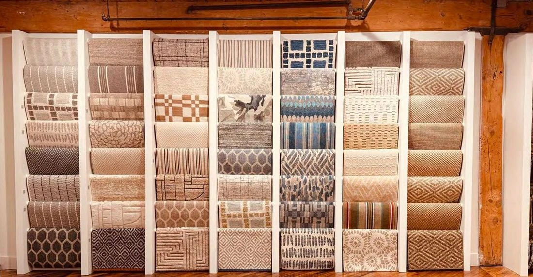 Folia Living showroom at High Point Market, a wall of new rug samples