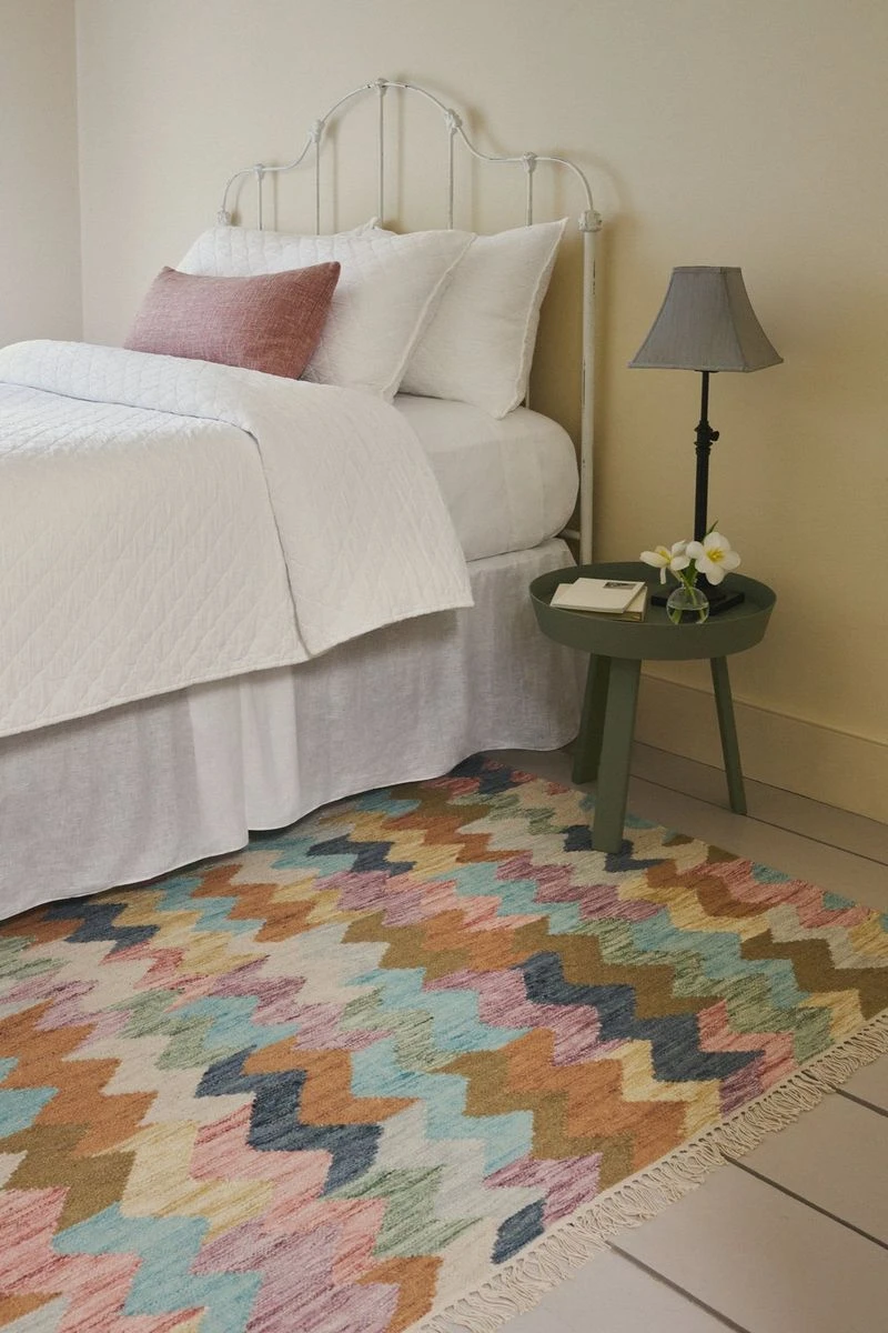 Siesta Multi kilim rug beside a bed
