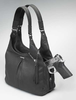 Concealed carry compartment is embedded in center of handbag for easy weapon access