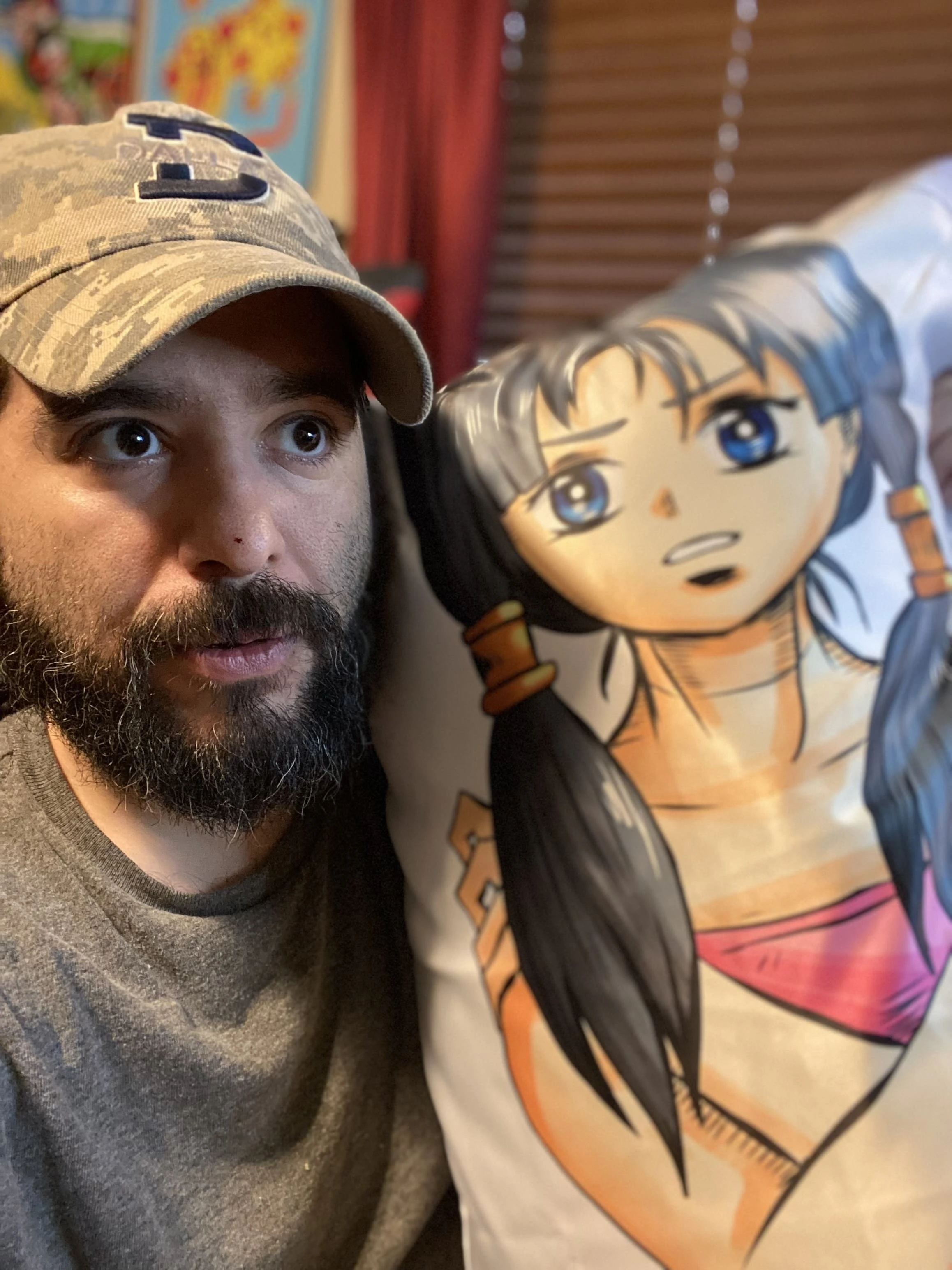 Person holding up a full-length anime body pillow