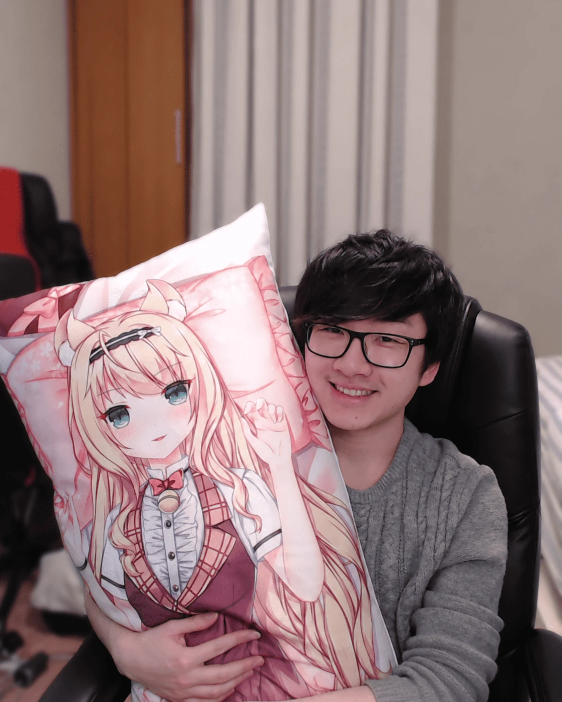 Person leaning on an anime body pillow