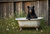 BIT010  "Mabel" Bear in a Cast Iron Tub in Front of Barn