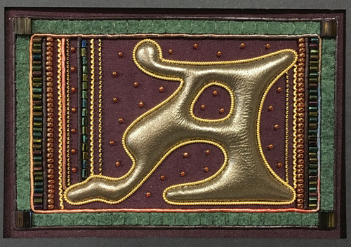 A - Purple Silk Background - Bronze Leather Letter