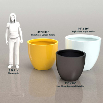 Group of Wannsee large round tree planters in yellow, white, and black finishes beside human silhouette