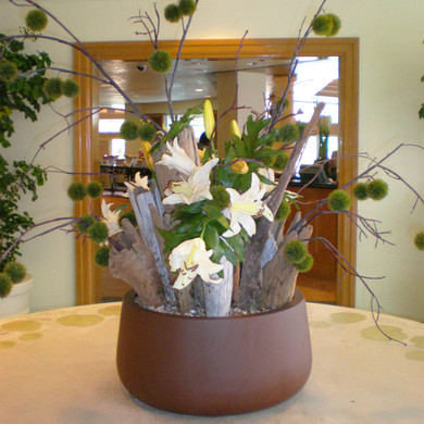 Short Hayden Tabletop Planter Pot in brown finish with floral arrangement on indoor table