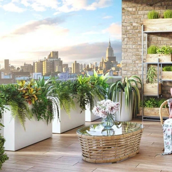 White modular 12-inch wide fiberglass planter boxes with lush greenery on modern rooftop patio