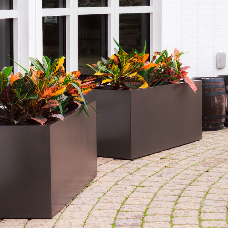 Tolga modern rectangular fiberglass planter boxes in dark finish with mixed plants on outdoor patio
