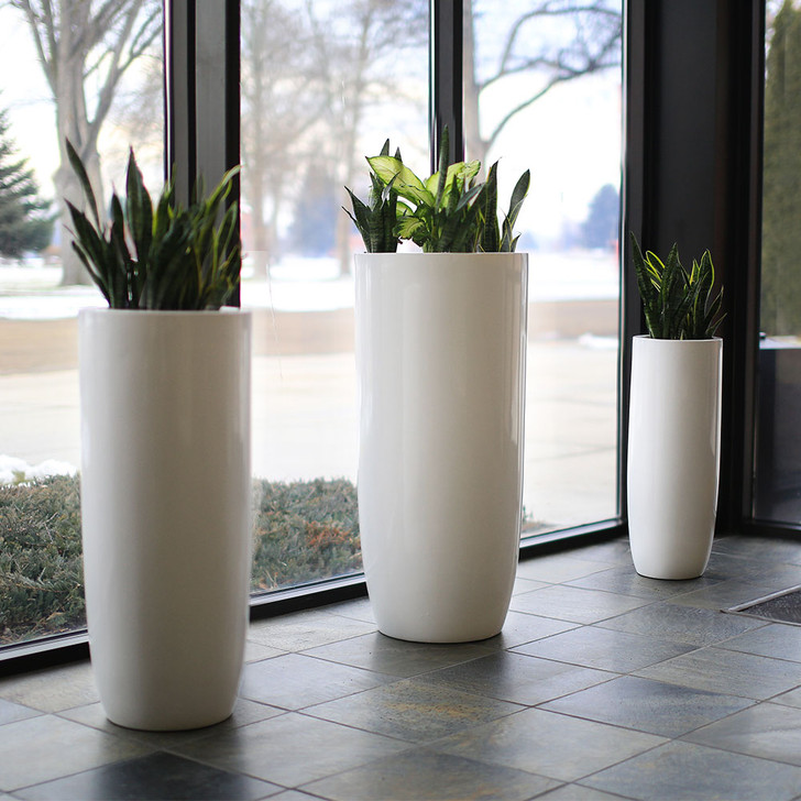 Saint Tropez tall vase fiberglass planter pots in white finish with snake plants in modern indoor lobby