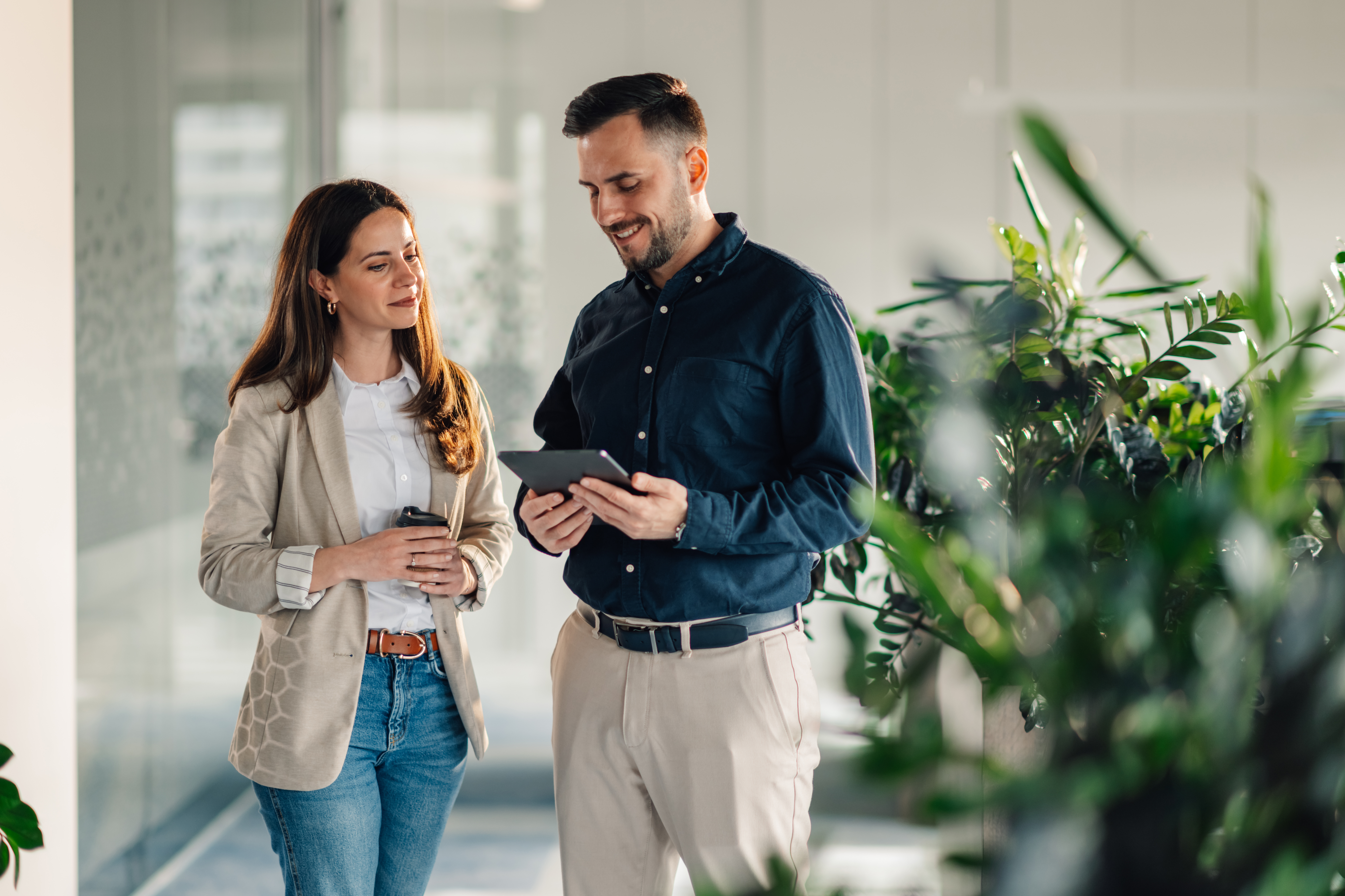 Employees collaborating on a project in a modern green office