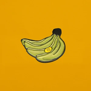 Soft enamel pin of plátanos with a yellow CENTRO sticker