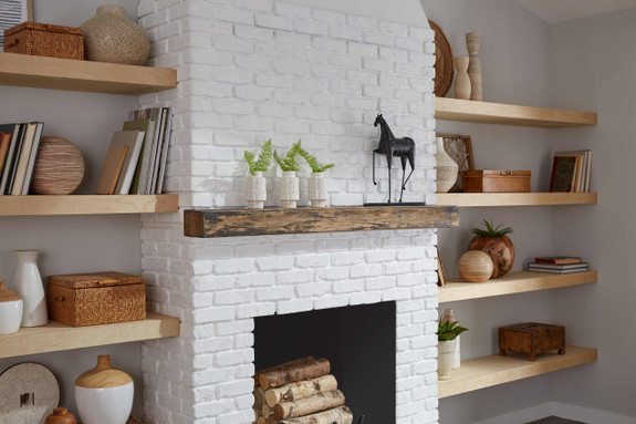 Dove White faux wall brick panels enhance a fireplace's design.