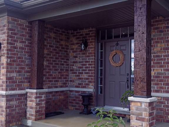Our Old Tuscan Faux Wood beams in the fresh coffee color used vertically to cover the columns to this front entrance.