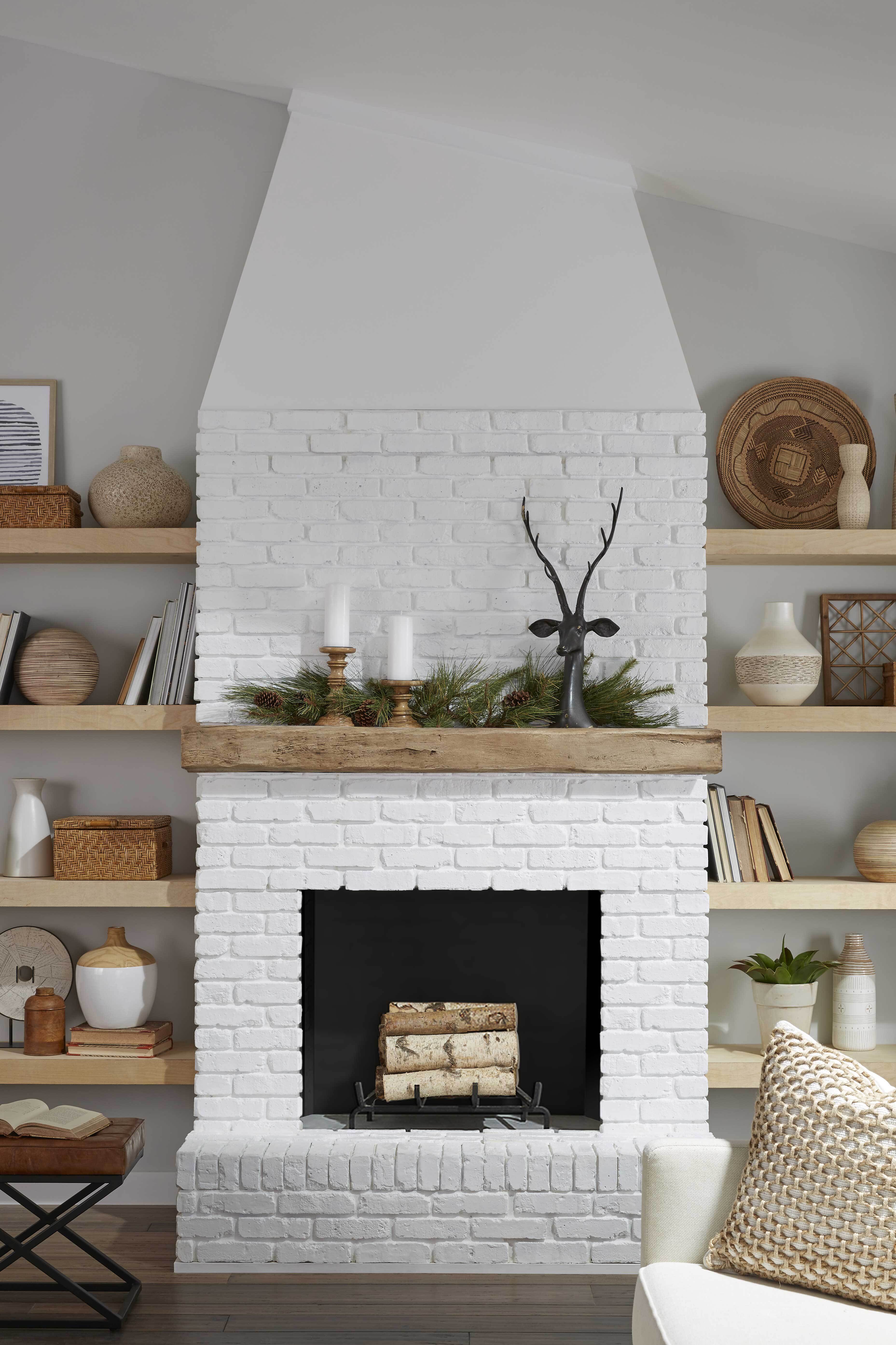 White painted brick fireplace featuring a Magnolia Faux Wood Mantel, finished by customer.