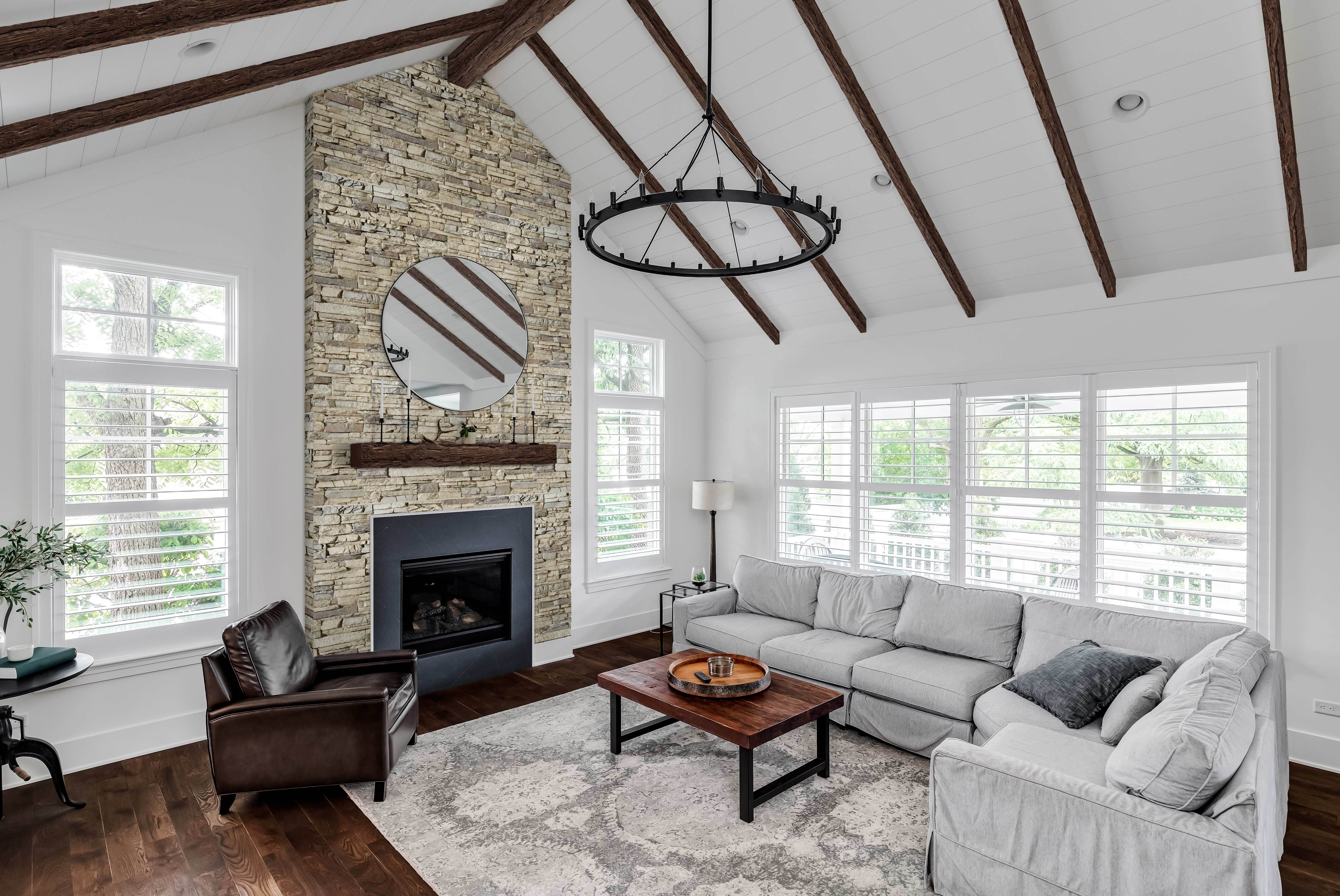 A living room featuring a fireplace with a Magnolia Faux Wood Mantel and Faux Wood Beams in Espresso Brown.