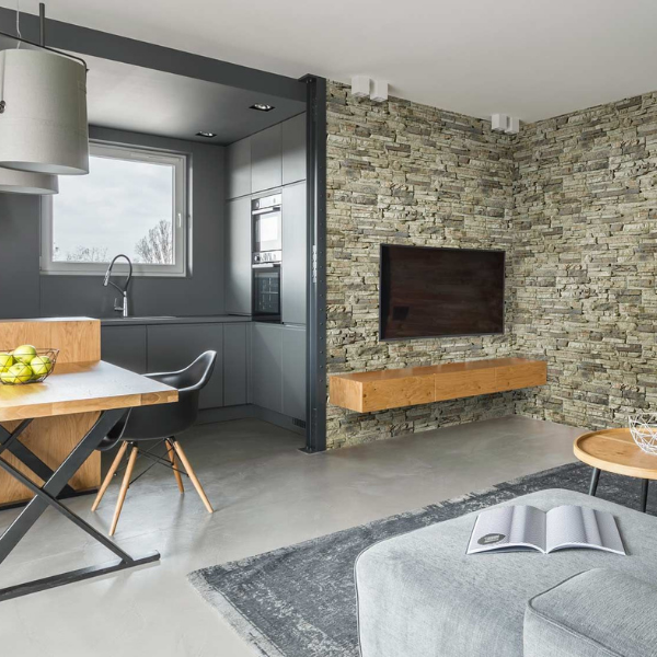 faux stone wall panel accent wall in modern kitchen and dining room area, faux stone accent wall behind tv
