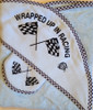Adorable Baby towel and washcloth set

 "Wrapped Up In Racing"

 Light Blue towel with checker flag trim

 Great gift for a baby shower!

 Machine washable