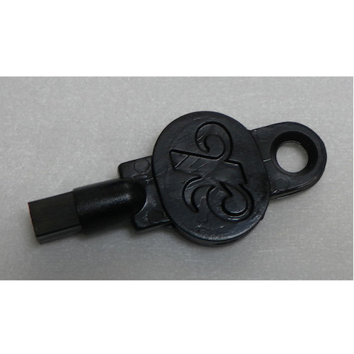 Black key for Kimberly Clark KC Dispenser 4971, made of metal with decorative design.