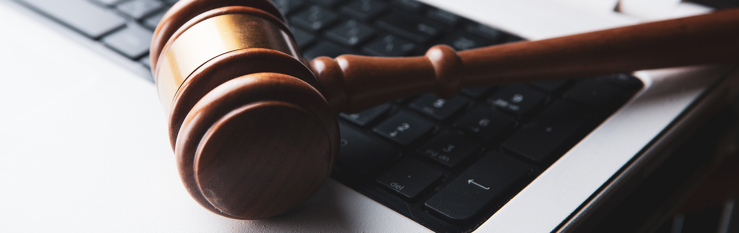 Gavel resting on computer keyboard