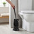 Black toilet brush and holder next to toilet in modern bathroom