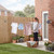 Retractable washing line in garden with clothes and woman hanging laundry