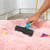 Blue pet hair remover roller being emptied, showing collected fur