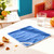 Bright blue microfibre cleaning cloth on table with crumbs, for kitchen or household use
