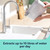 Portable dehumidifier water tank being emptied into a kitchen sink