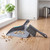 Grey dustpan and brush on kitchen counter with biscuit crumbs