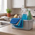 Cleaning caddy with spray bottles, cloths and brush on kitchen worktop