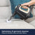 Handheld steam cleaner removing grout stains from tiled wall