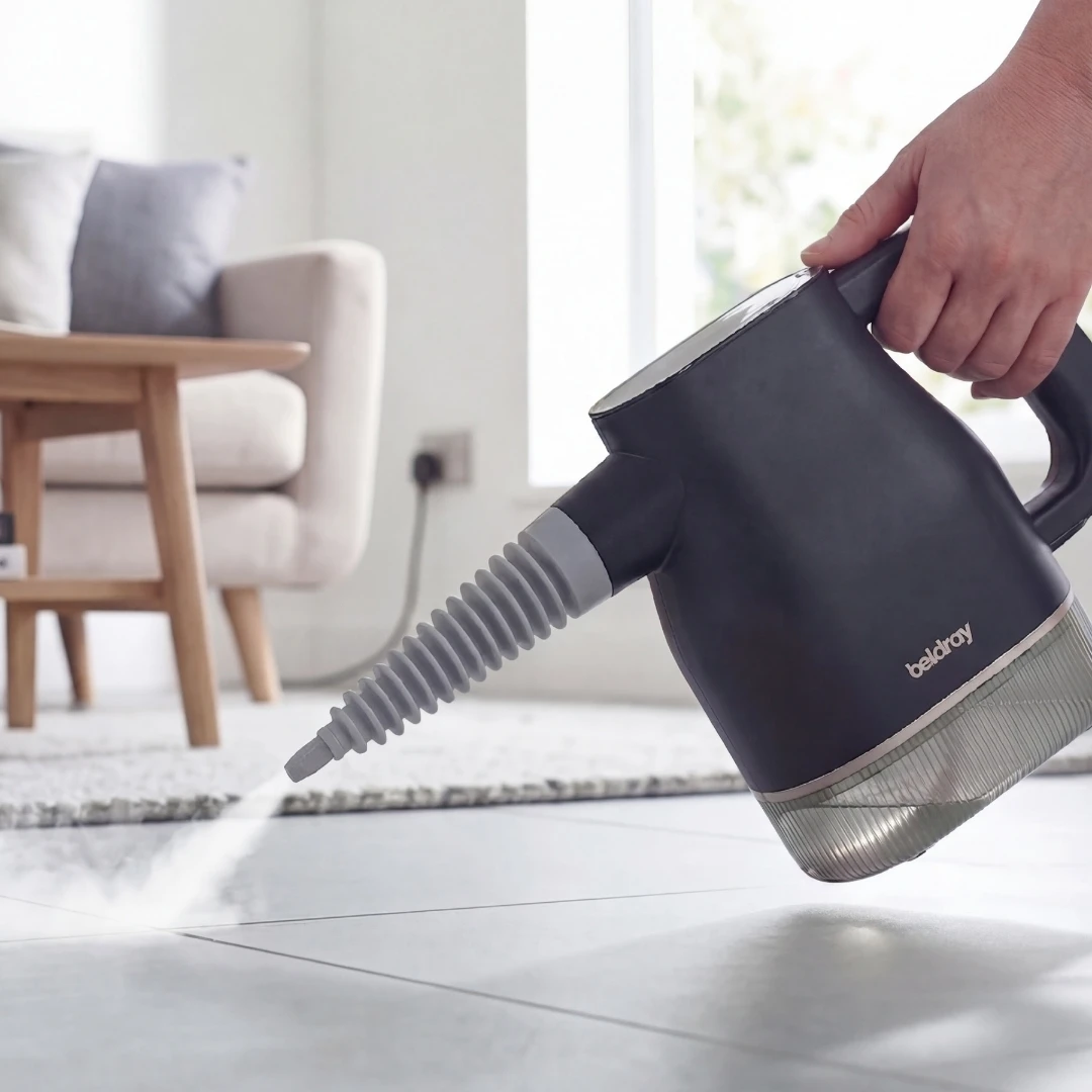 Beldray Digital Steam Cleaner spraying steam across a tiled floor in a bright living room.