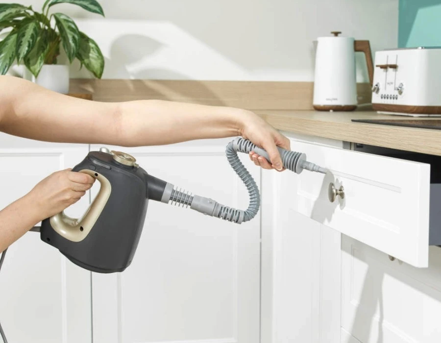 15-in-1 Steam Cleaner being used to clean a kitchen drawer front with a flexi nozzle.