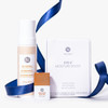 A bundle of Neora skincare products, which include 3-in-1 Self Tanning + Sculpting Foam, Bronze Drops, Hydrogel Eye Patches, surrounded by blue ribbons.