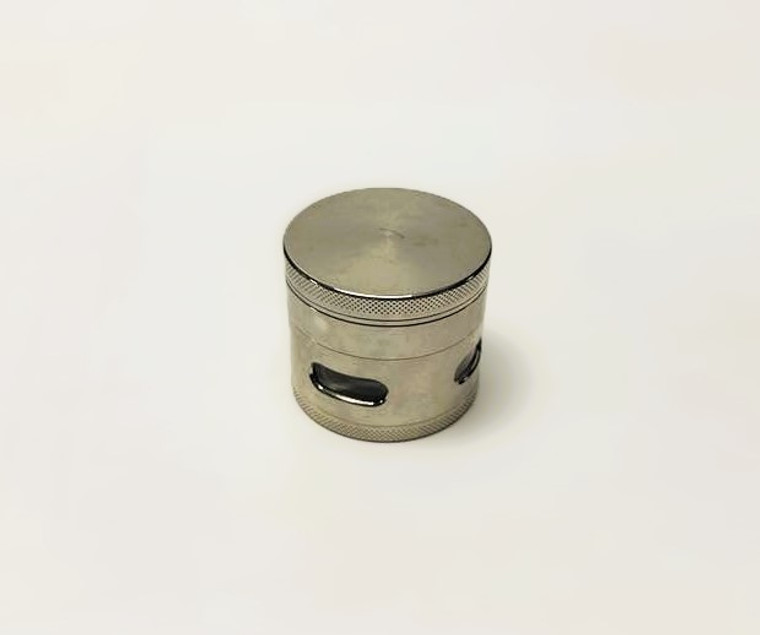2.5in 4pc METAL GRINDER with BOTTOM VIEW WINDOW, KNOTCHED FINGER GRIPS, and KEEF SCRAPER. SILVER COLOR.