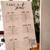 Laser cut and engraved white wedding seating chart with black writing.  Take a seat.