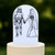 An elaborate cake topper showing a black outline of a storm trooper holding hands with a bride in a mermaid style dress, on a white background.
