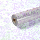 A roll of Soft Green & Lilac Flower Confetti Print Clear Film, measuring approx. 80cm x 80m.