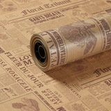A roll of Mocha Newspaper Sienna Print Kraft Paper, measuring approx. 75cm x 50m.