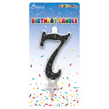 A 6cm black glitter number 7 candle, manufactured by Sensations.