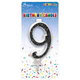 A 6cm black glitter number 9 candle, manufactured by Sensations.