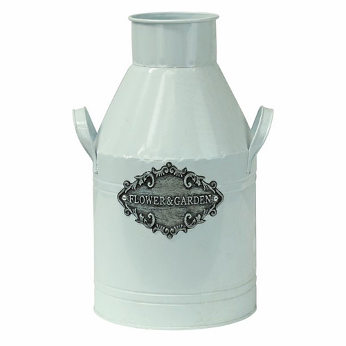 A white metal milk churn. A white metal milk churn.