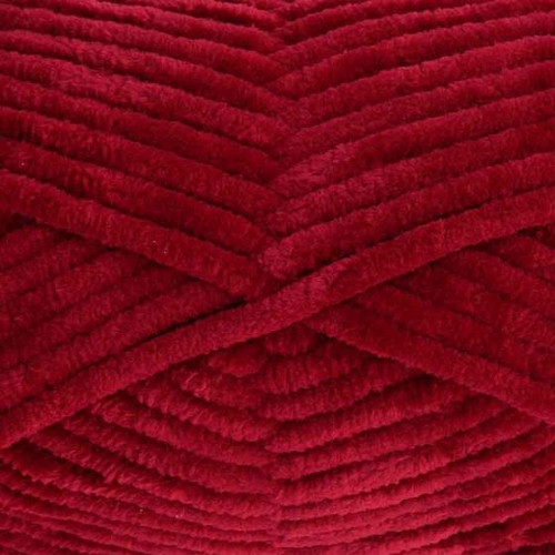 A 100g ball of Yummy Chunky Burgundy Polyester Yarn, manufactured by King Cole.