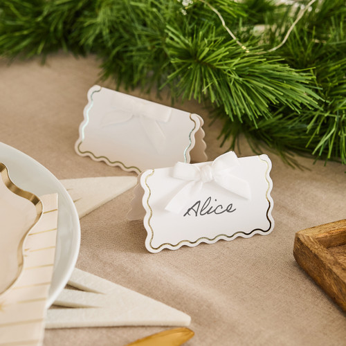 A pack of 8 White & Gold Wavy Edge Place Cards with Velvet Bows.